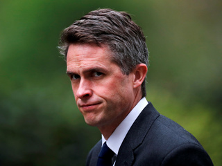 UK's May Fires Defence Secretary Over Huawei Leak